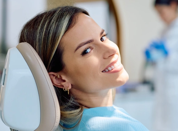 Woman relaxing in dental chair during examination at modern dental office.