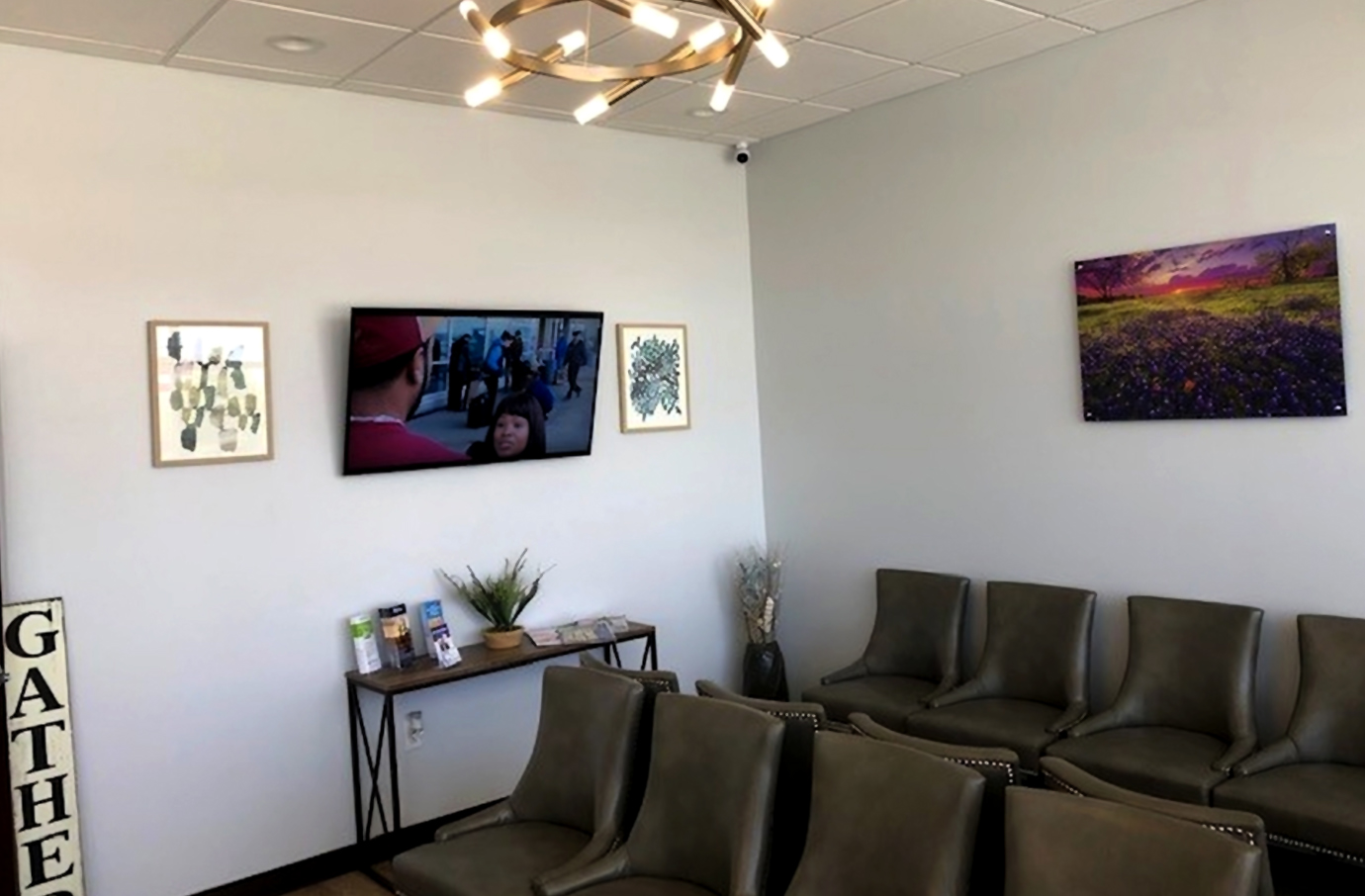Modern dental waiting room with comfortable seating, artwork on walls, and contemporary décor.